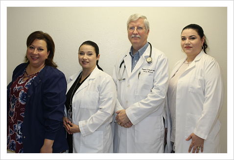 Family Health Clinic staff smiling. There is three females and one male