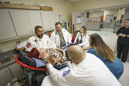 Medical Professional working on female patient