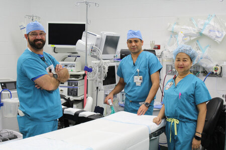 Surgical Services team smiling. There is one female and two males